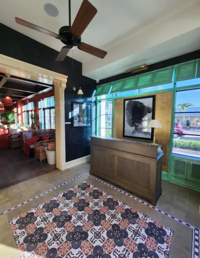 A lobby with a tiled floor and a ceiling fan.