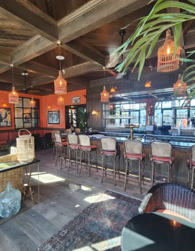 The bar area of a restaurant with a tropical theme.